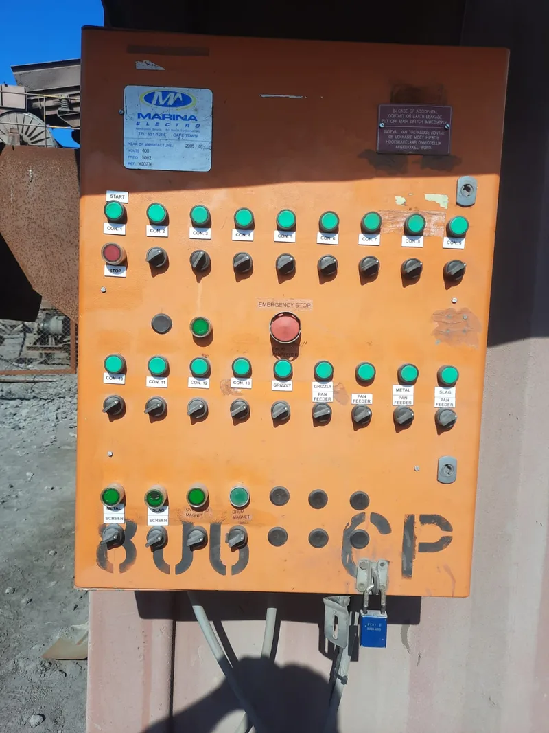 Orange industrial control panel with labelled switches and indicator lights.