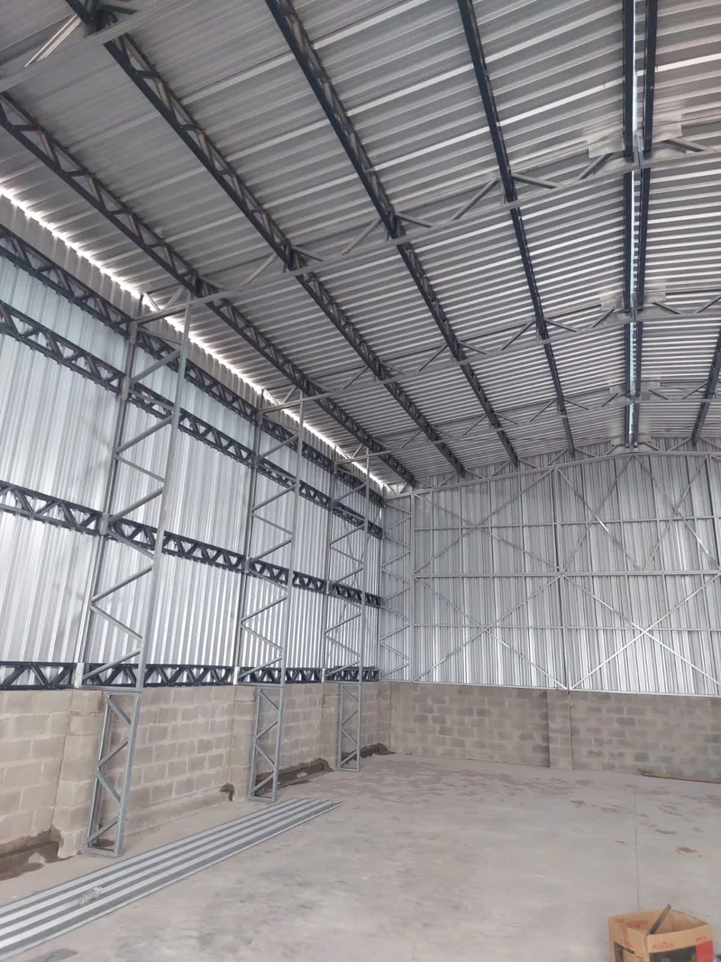 Interior of the erected Saldanha structure showing steel roof framing and wall cladding.